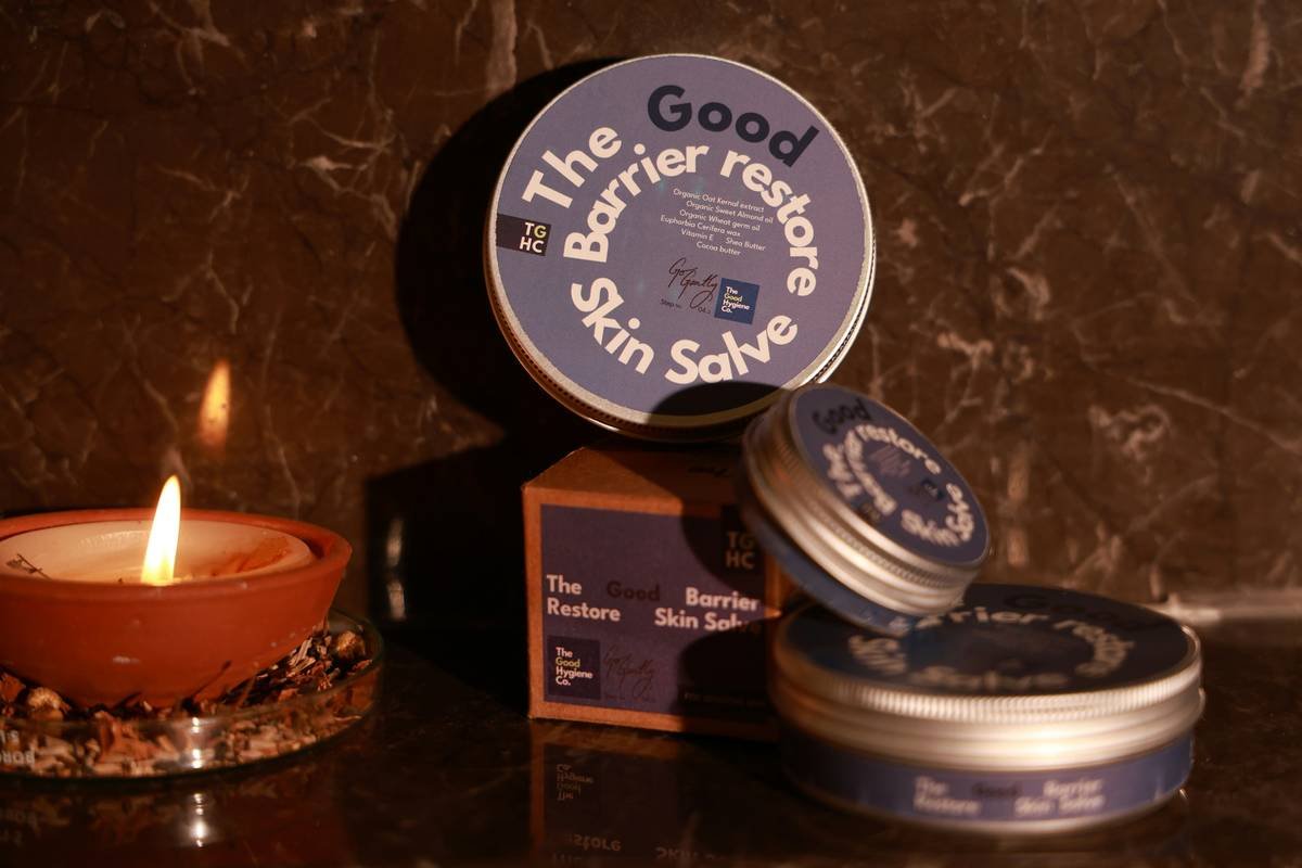Woman applying healing protective balm to wind-chapped cheeks in winter